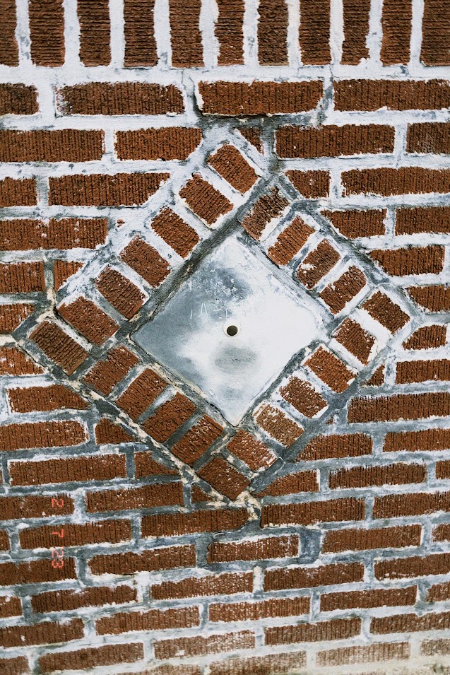 february 7, 2023: a plastic googly eye stuck to a brick wall.