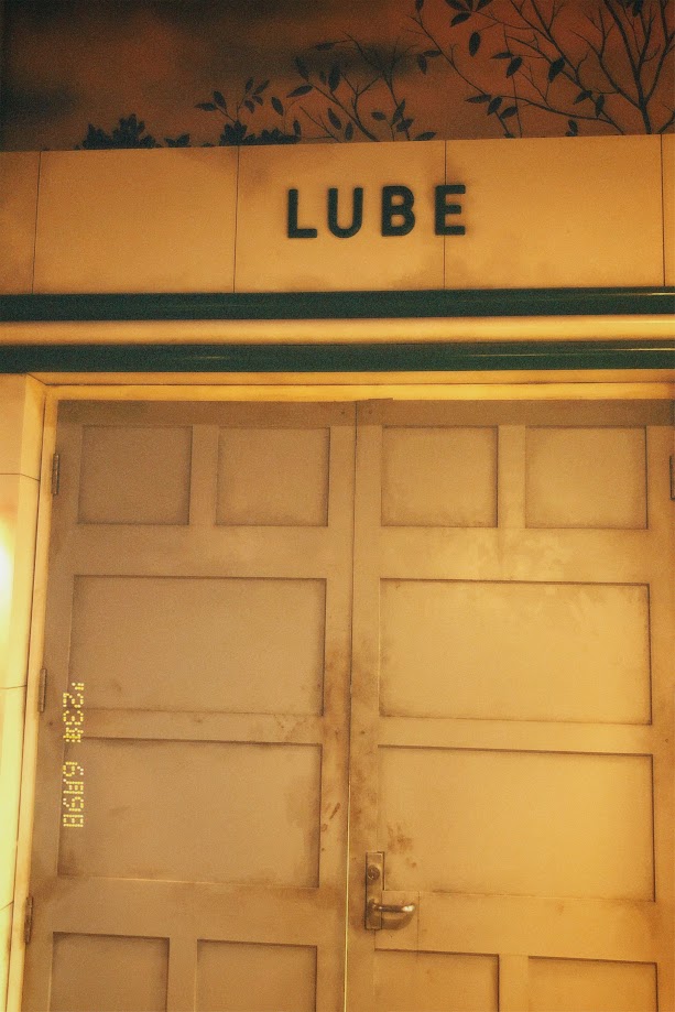 june 9, 2023: the word 'Lube' written on the wall of a service station in COSI's Progress.