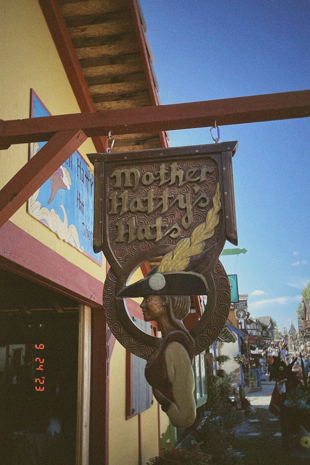 september 24, 2023: a carved wooden sign for Mother Hatty's Hats.