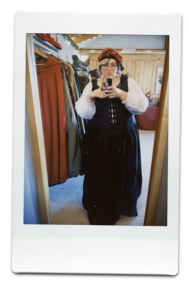 september 24, 2023: a mirror selfie of jude dressed in a black skirt, black corset, and a white blouse.